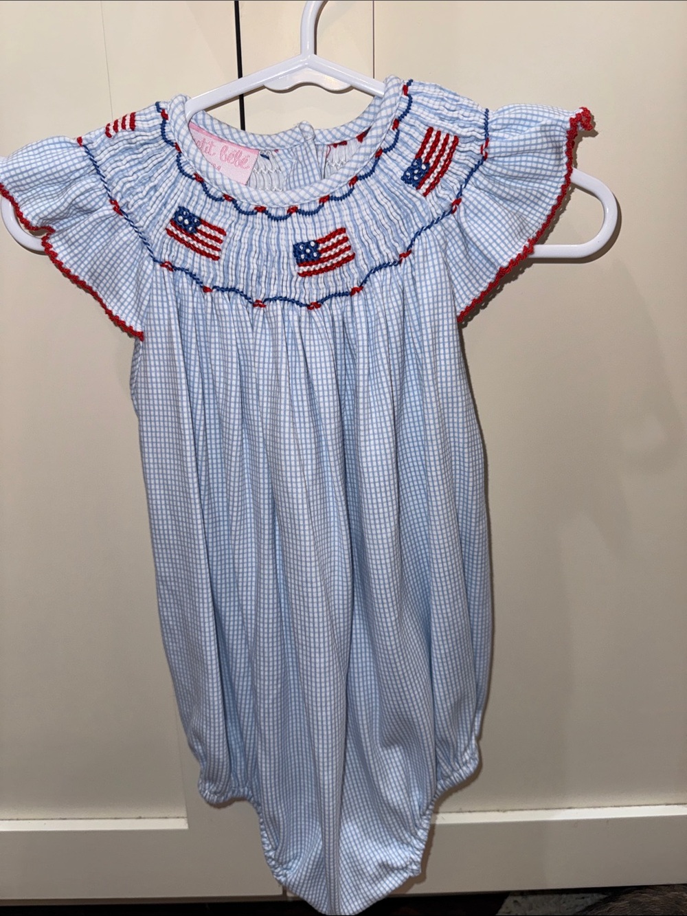 Petit Bebe Blue Gingham Smocked Romper with Red Trim and Flag embroidery